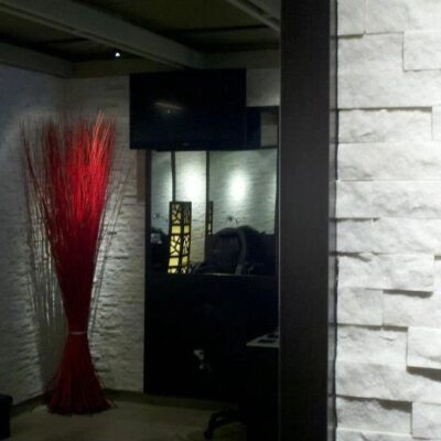 Elegant white stacked-stone accent wall in the salon