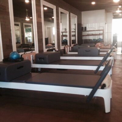 Close-up of the wood accent wall and modern lighting fixtures in the Pilates studio.