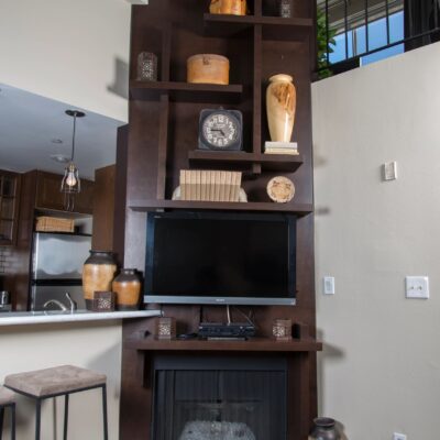 Custom floor-to-ceiling fireplace with integrated shelving and media.